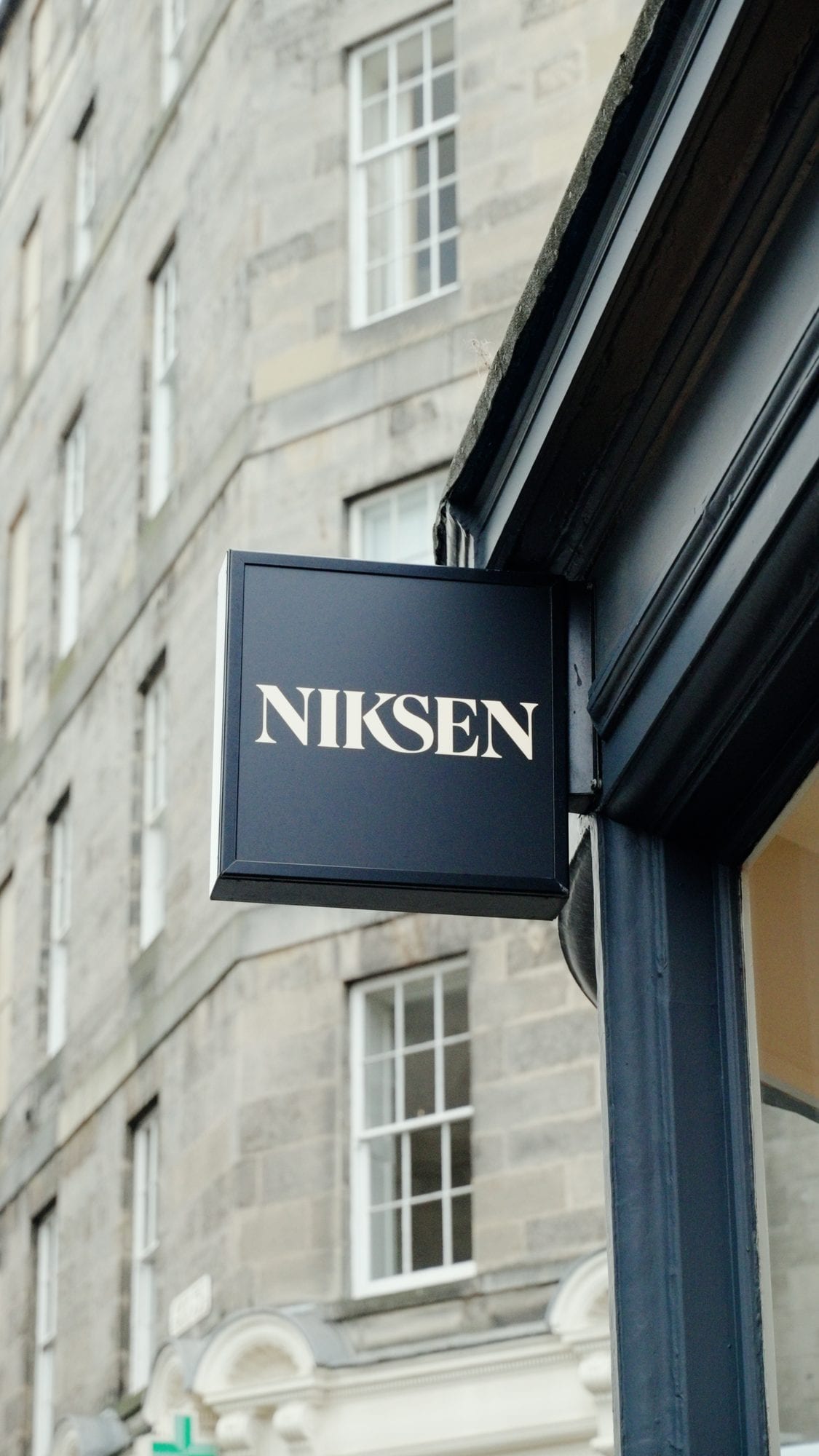 The Niksen shopfront sign on an Edinburgh street